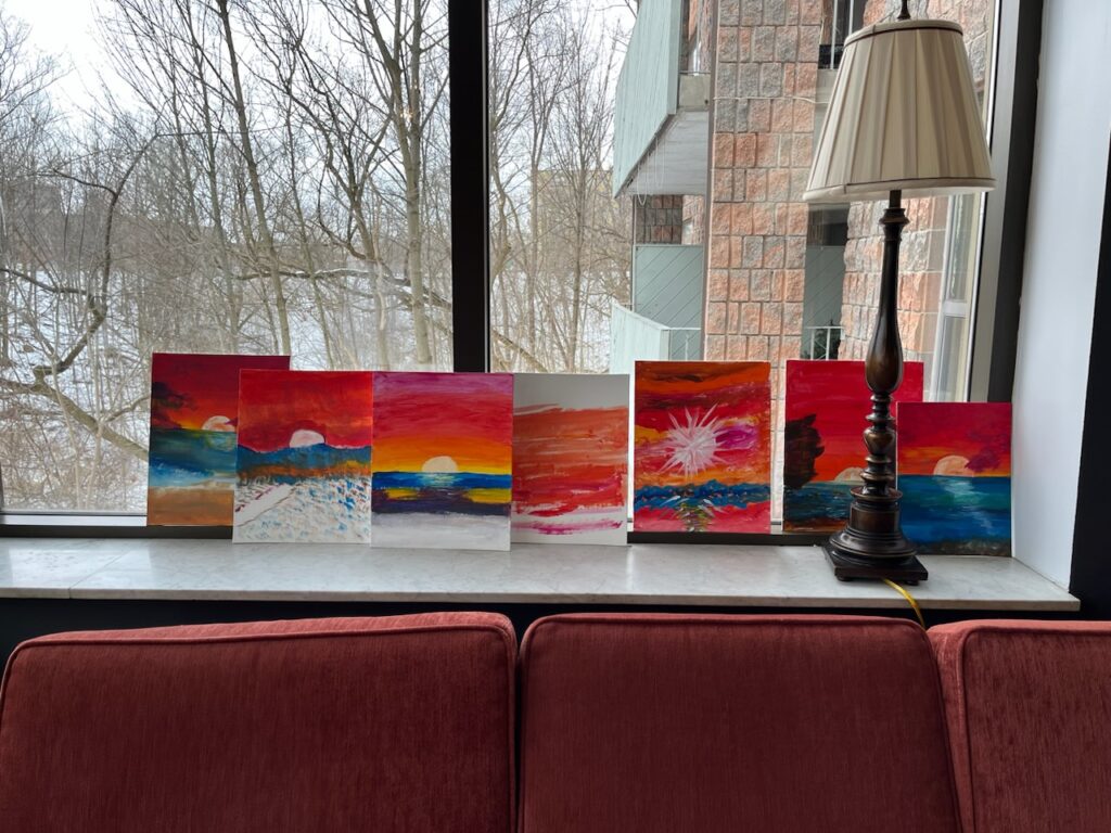 7 canvas with paintings of a sunset.