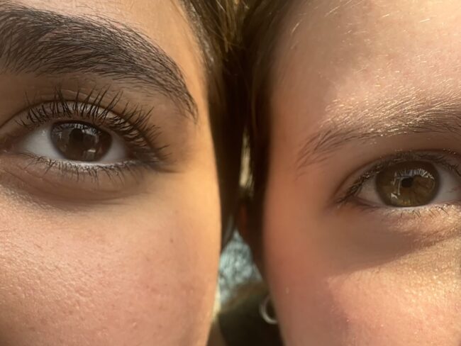 Two people's eyes side by side staring into the camera