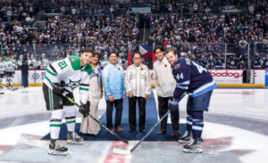 Puck drop at the Filipino heritage night with two hockey players 