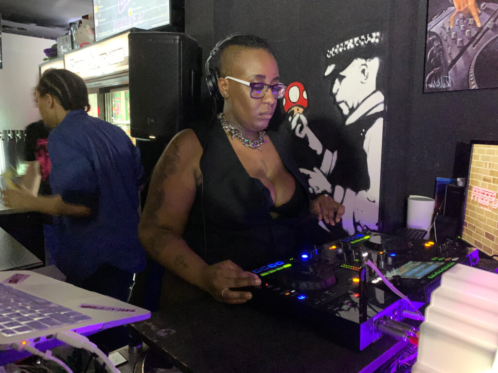 Person using a turntable to DJ for the event.