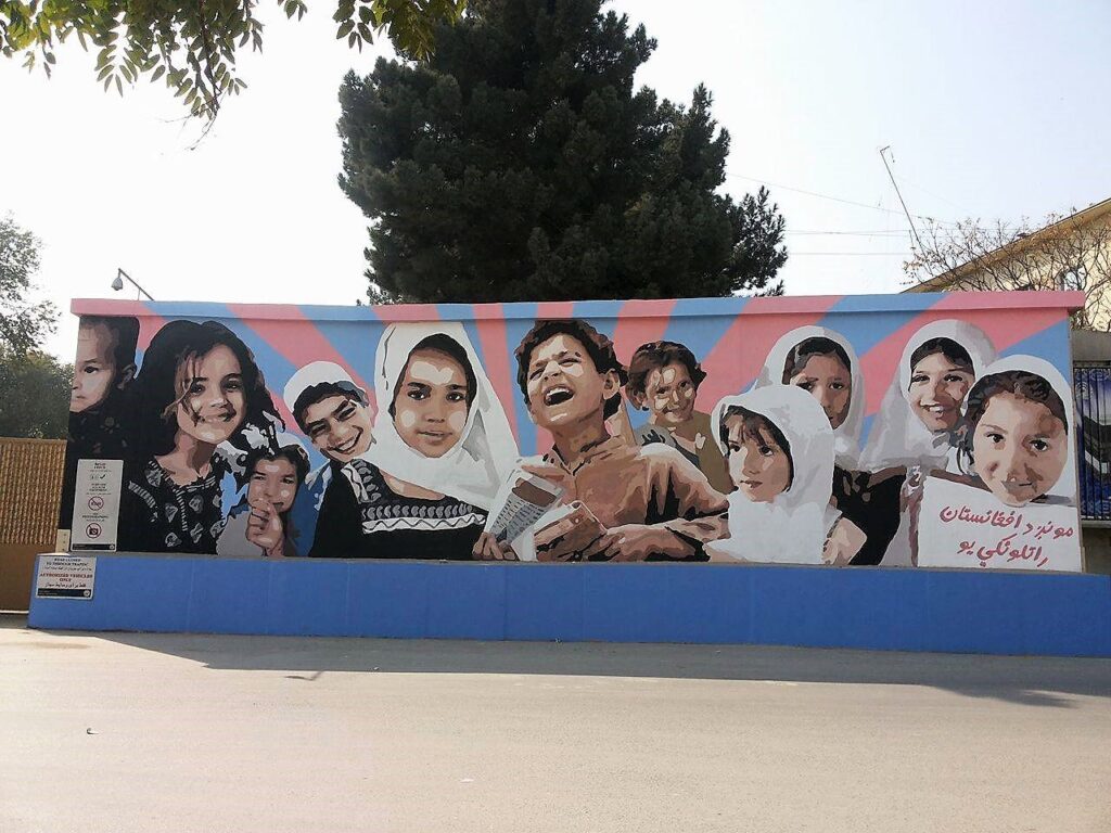 A painting of children with the writing "we are Afghanistan's future"