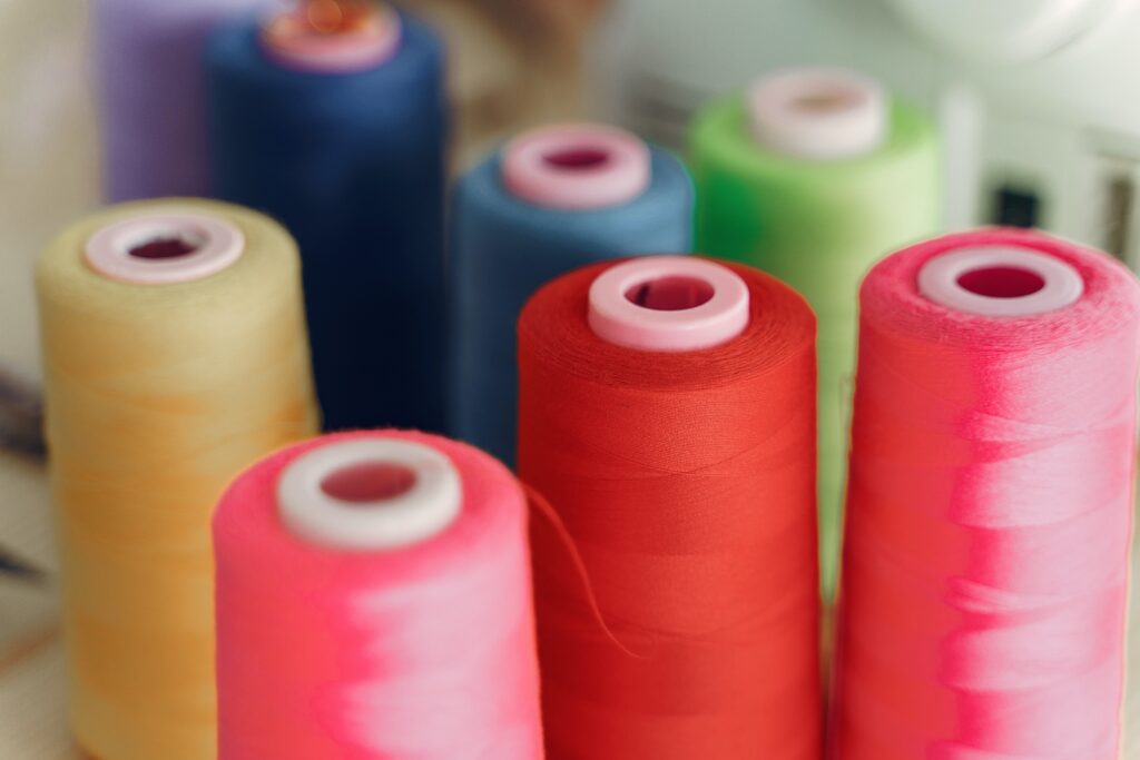 Red, pink, blue, green, and yellow thread.