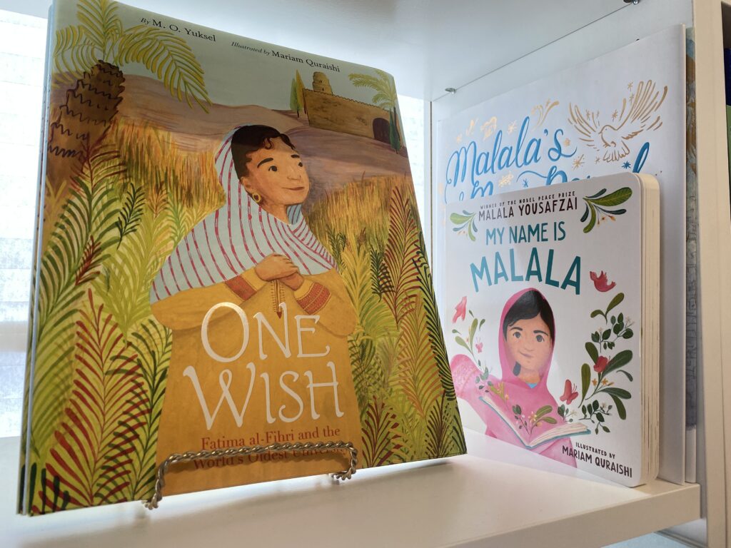 A close up of a children’s book called One Wish. The book’s cover is a cartoon of a young, hijabi girl.
