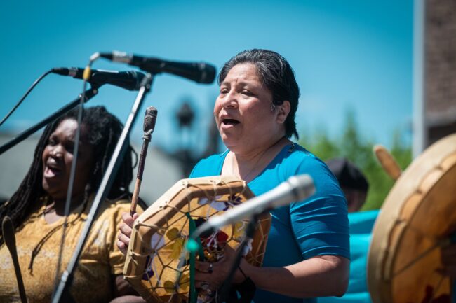 Close-up image of Spirit Wind members performing traditional First Nations songs.