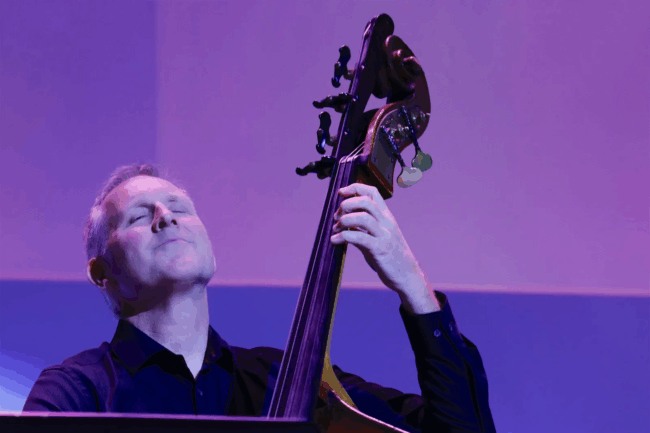 By Sanja Antić Man closing his eyes while playing an acoustic bass