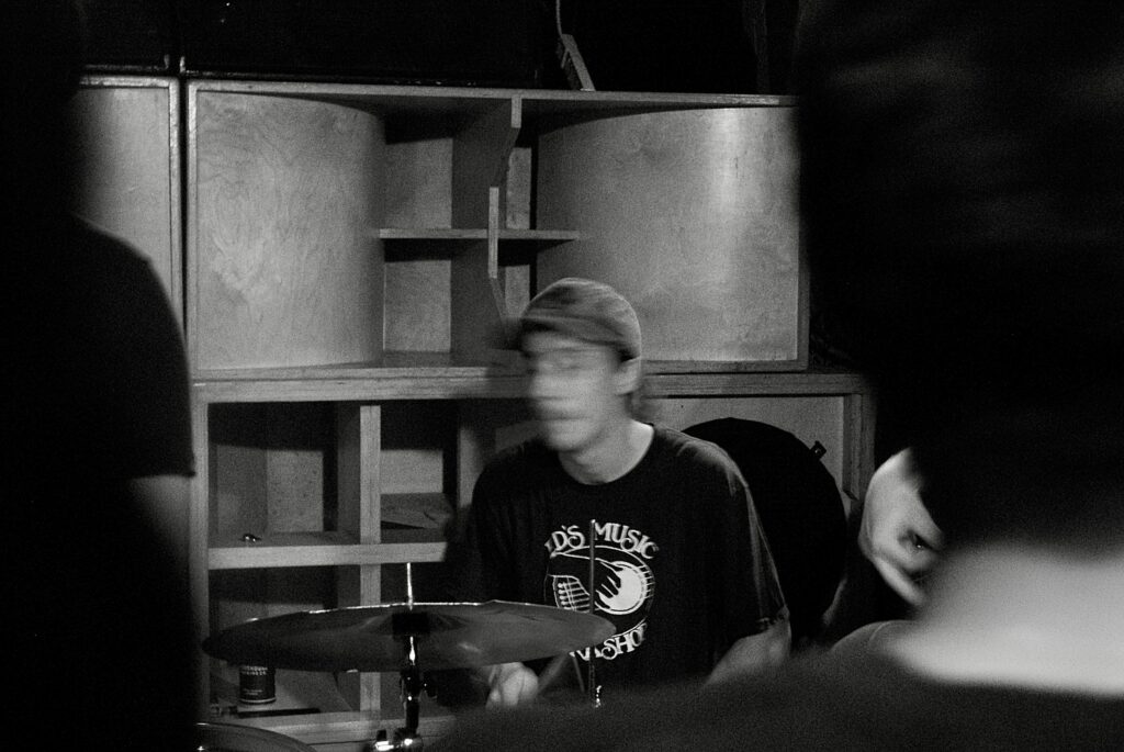 Drummer playing the drums. Face is blurry.
