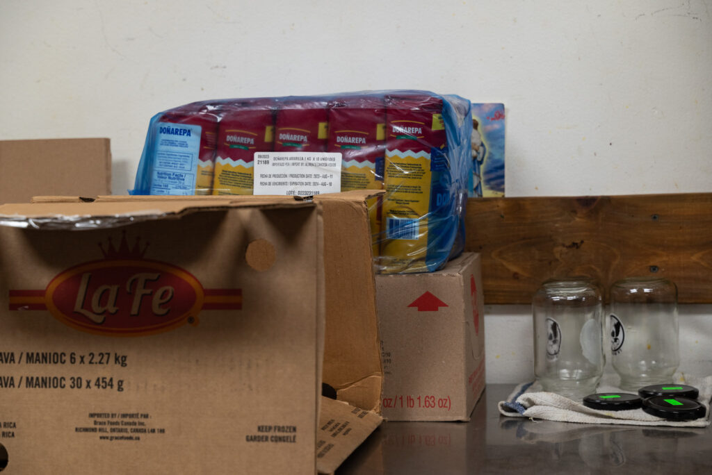 Boxes of supplies including flour on a counter.
