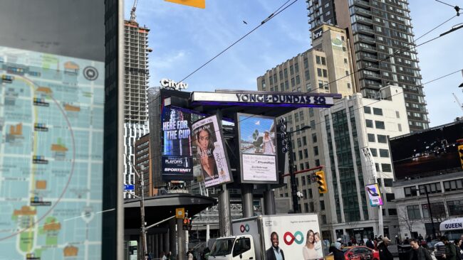Yonge-Dundas Square sign with digital billboards underneath it