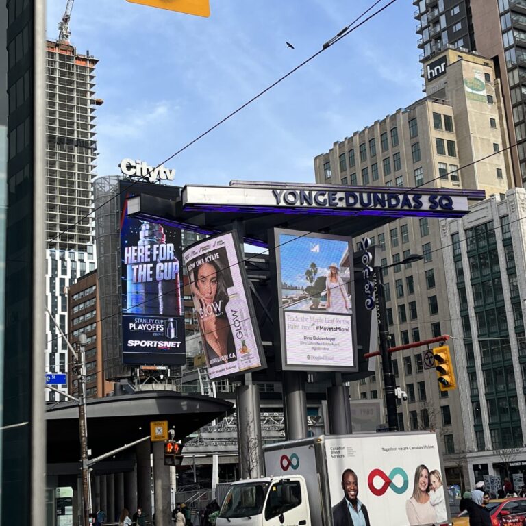 Yonge-Dundas Square sign with digital billboards underneath it