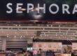 The entrance to a store that says "Sephora" in white capital letters at the top of the entrance, with a glimpse of the store at the bottom.