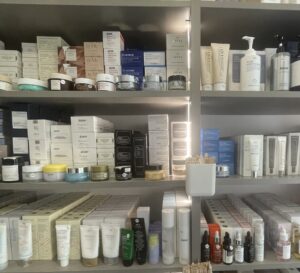 A shelf with bottles of different cleansers stacked three shelves high.