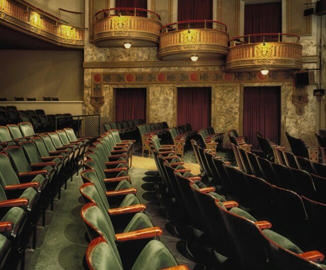 Empty grey theater seats with balconies showing the dying music industry